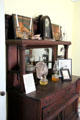 Sideboard with antiques in Muenzler House at Pioneer Village. Gonzales, TX.