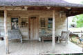 Gates house with rocking log furniture at Pioneer Village. Gonzales, TX.