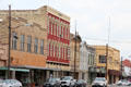 Commercial heritage streetscape including red Masonic building. Gonzales, TX.