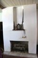 Fireplace, powder horn & rifle in Baetge House at Conservation Plaza. New Braunfels, TX.