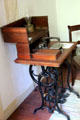 Treadle sewing machine & oil lamp in Baetge House at Conservation Plaza. New Braunfels, TX.