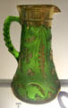 Green glass with applied gold Delaware-pattern pitcher from Pittsburgh, PA at Bennington Museum. Bennington, VT.