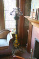 Wrought iron floor oil lamp in west hall sitting area at Park-McCullough Historic Estate. North Bennington, VT.