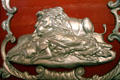 Carving of lion guarding sleeping woman on red & silver circus wagon at Circus World Museum. Baraboo, WI