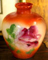Milk glass vase with orange color gradient & flowers at Fostoria Glass Museum. Moundsville, WV.
