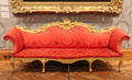 Camelback Sofa made in London a part of 19 piece suite for Great Drawing Room at 45 Berkley Square, framed in gilt lime & beech with scarlet upholstery at National Museum of Wales. Cardiff, Wales.