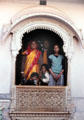 A family peers out from a window of Jaiselmer Palace. India.