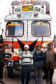 Truck drivers pose with their ornate truck. India