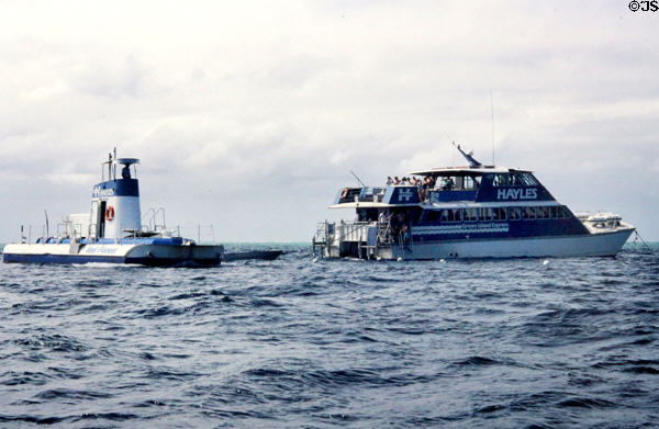 Boats & a submarine allow people to view Barrier Reef of Cairns. Australia.