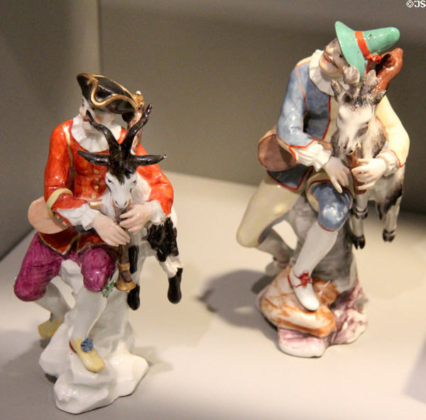 Meissen porcelain Harlequin figurine playing goat bagpipes (1736-40) by Johann Joachim Kändler plus derivative copy on right (c1750-55) by Höchst of Frankfurt at Gardiner Museum. Toronto, ON.