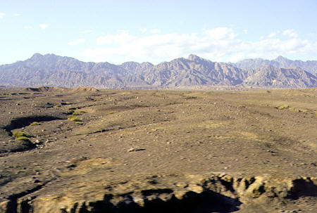 Mountains in the distance seen from train between Turpan and Dunhuang. China.
