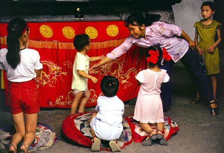 Children praying in Chengdu. China.