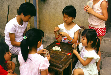Children playing cards in a tea-growing village in Hangzhou. China.