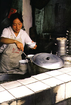 Serving dumplings at a restaurant in Chengdu. China.