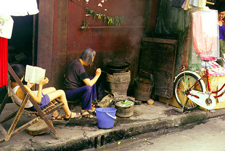 Cooking over coals in the street in Chengdu. China.