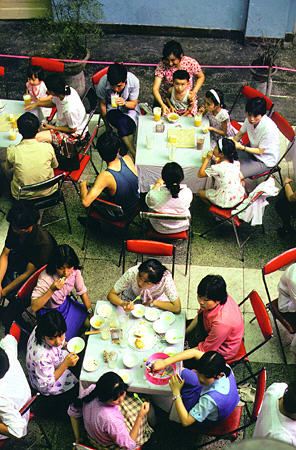 Overlooking patrons eating at a restaurant in Chengdu. China.