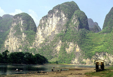 Steep hills form the boundaries of the Li River, Kweilin. China.