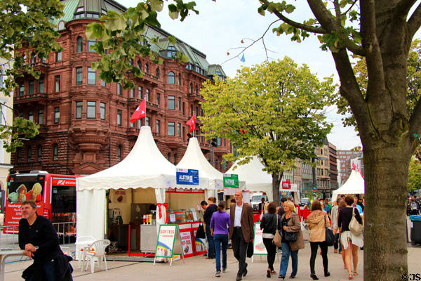 People strolling by food booths along Lake Alster. Hamburg, Germany.