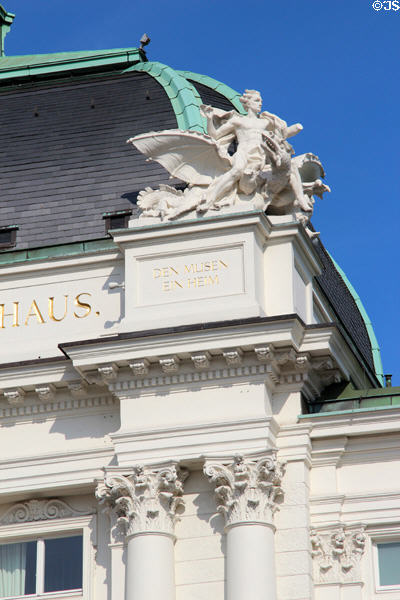 Roof top statue inscribed "A Home for the Muses" at German Theater. Hamburg, Germany.