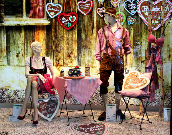 Germanic scene in shop window with people in lederhosen costume. Hamburg, Germany.