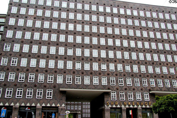 Sprinkenhof (1927-43) (nearby Chilehaus) features lozenge-shaped painted brick & regularly arranged ceramics depicting economic, trade and transport motifs. Hamburg, Germany. Style: Brick Expressionist. Architect: Hans and Oskar Gerson & Fritz Höger.
