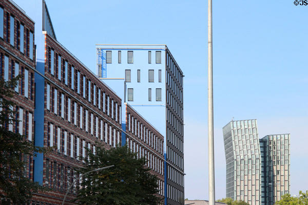 Red. white & gray brick commercial building with view along Ludwig-Erhard-Straße B4. Hamburg, Germany.