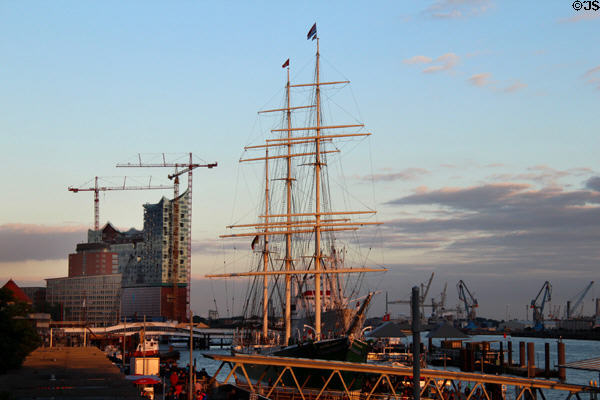 Rigging on Rickmer Rickmers museum sailing ship with modern concert hall under construction in background. Hamburg, Germany.