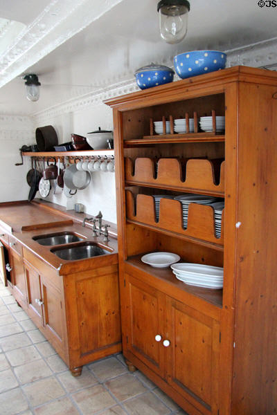 Cupboard built to prevent dinner plates sliding out in rough seas on Rickmer Rickmers museum sailing ship. Hamburg, Germany.
