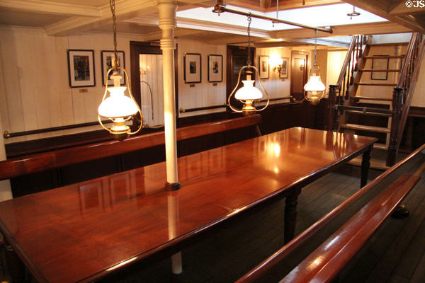 Elegant hardwood table & lights on board Rickmer Rickmers museum sailing ship. Hamburg, Germany.