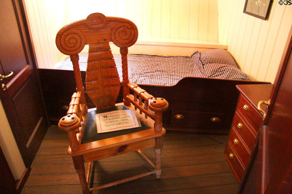 Elaborately carved chair with naval themes on board Rickmer Rickmers museum sailing ship. Hamburg, Germany.