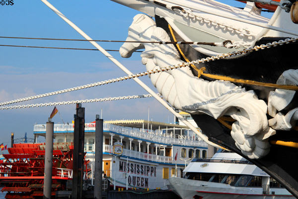 Sea horse figure head on Morgenster tall ship with Mississippi Queen paddle wheeler in background. Hamburg, Germany.