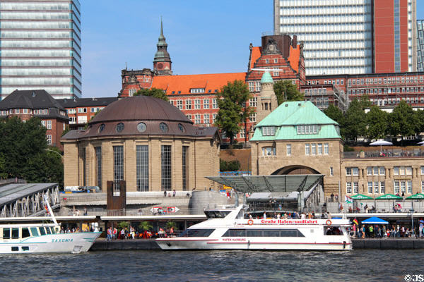 Brown dome of Alter Elbtunnel century old tunnel under Elbe & green spires of bridge 6 building of St Pauli Pier. Hamburg, Germany.