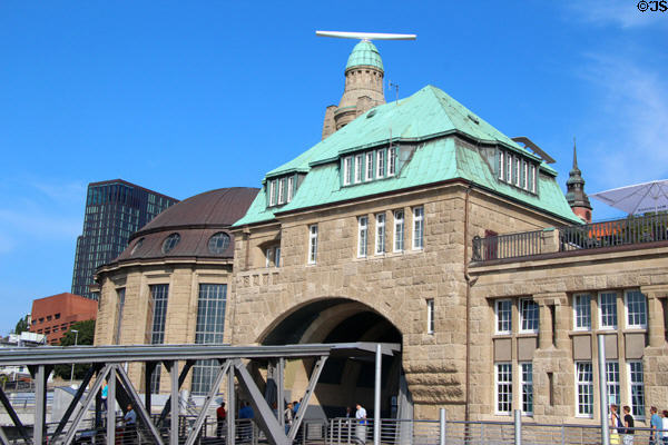Brown dome of Alter Elbtunnel century old tunnel under Elbe & green spires of bridge 6 building of St Pauli Pier. Hamburg, Germany.