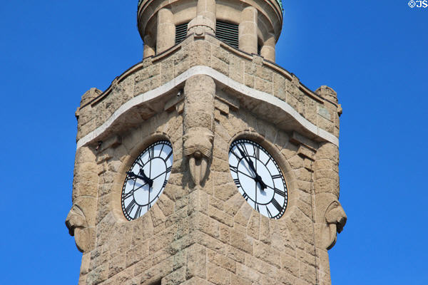 Detail of carved walrus heads on stone clock tower at St Pauli Pier. Hamburg, Germany.