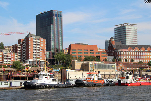 Empire Riverside Hotel Hamburg (2006) (black) & Astraturm St.Pauli (2007) (silver with square rail) along Bernhard-Nocht-Straße with tug boats on Elbe. Hamburg, Germany.