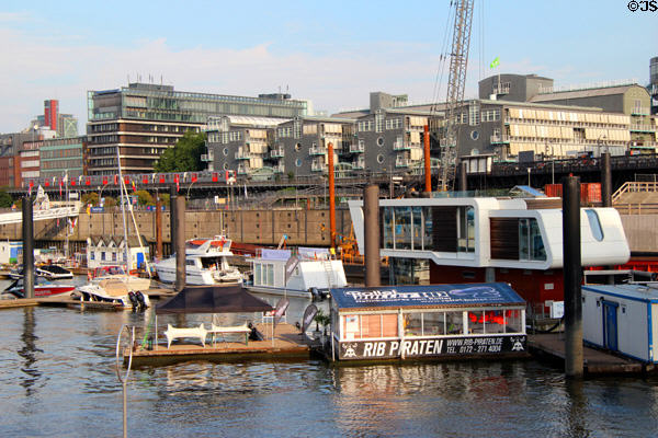 White floating house with Hamburg New City beyond. Hamburg, Germany.