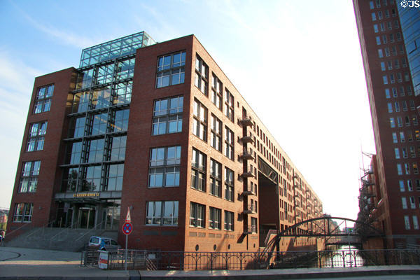 Brick building with glass atrium at Kehrwieder 12 in HafenCity district. Hamburg, Germany.