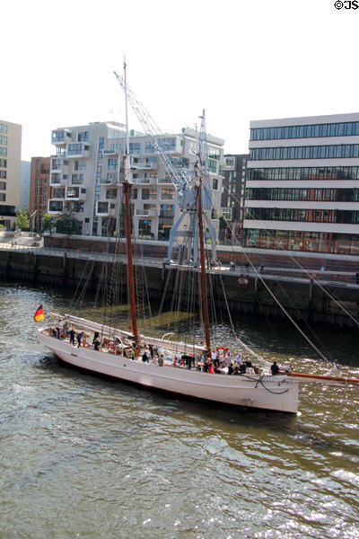 Sailing ship on Elbe River passing in front of HafenCity. Hamburg, Germany.