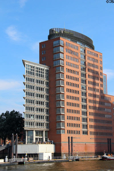 Modern brick & glass office building across canal from Elbphilharmonie in HafenCity. Hamburg, Germany.