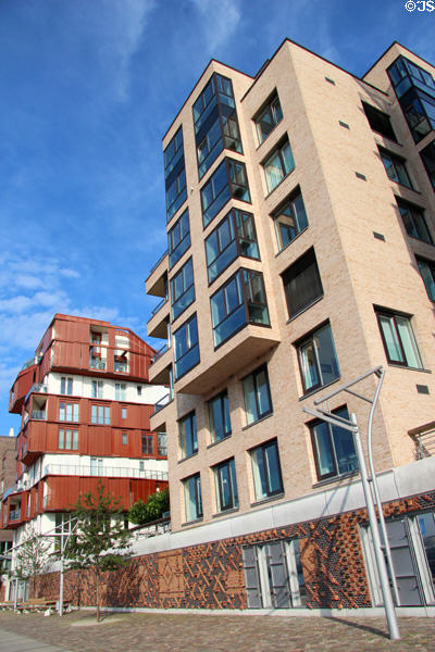 Modern buildings above decorative brickwork flood barrier wall on Dalmannkai in HafenCity. Hamburg, Germany.