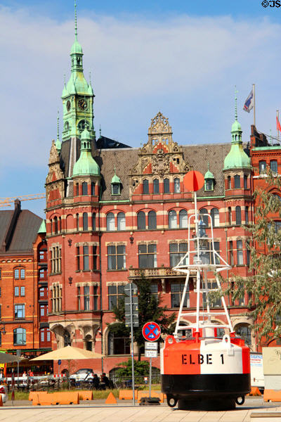 Heritage buildings on Holländischer Brook canal beyond square with Elbe 1 buoy. Hamburg, Germany.
