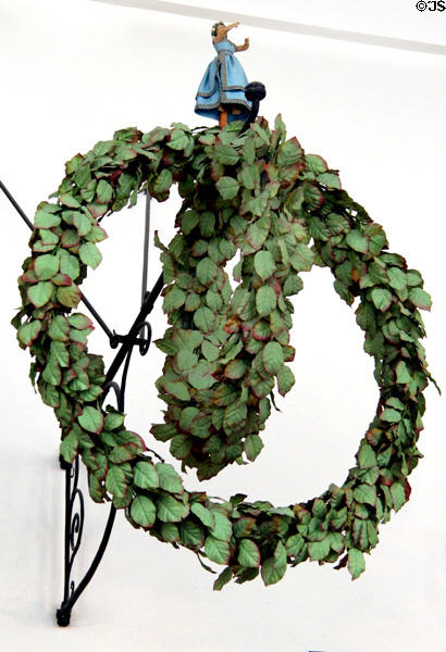 Historic wrought iron sign with maiden on wreath at Hamburg History Museum. Hamburg, Germany.