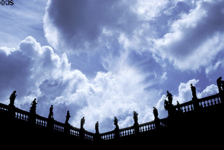 Roofline of Neues Palais set with baroque statues against dramatic sky. Potsdam, Germany.
