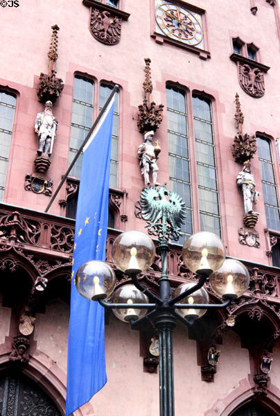 Ornamental street lighting in front of statues of three of four Holy Roman Emperors on Haus zum Römer. Frankfurt am Main, Germany.