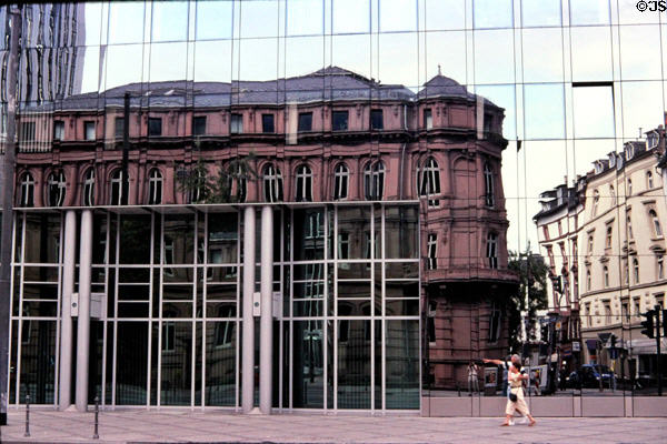 Early 20thC building reflected on mirrored facade of skyscraper. Frankfurt am Main, Germany.