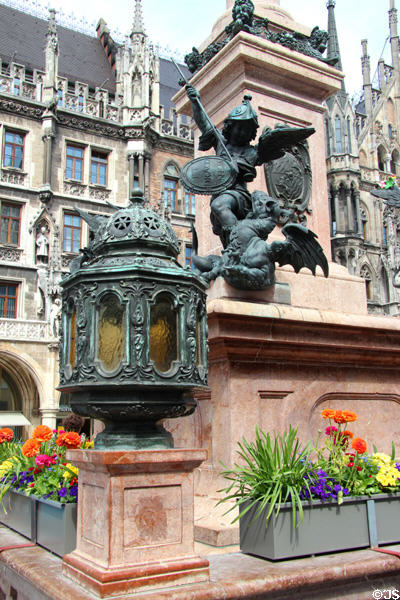 Lantern & St Michael slaying Dragon on base of Marien column at Neues Rathaus. Munich, Germany.