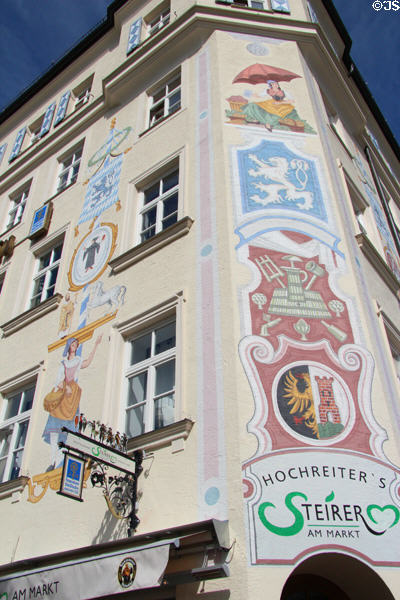 Building painted with beer brands at Viktualienmarkt. Munich, Germany.