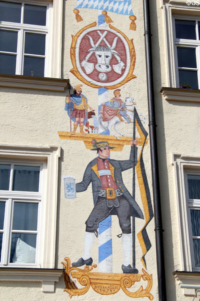 Pole with beer history from Roman to German times wall painting (1974) by Bertram Müller at Viktualienmarkt. Munich, Germany.