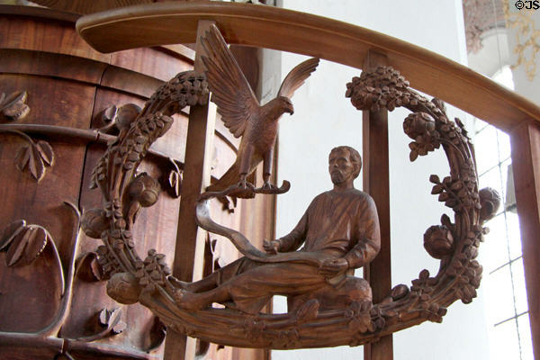 Modern pulpit carving of Evangelist St John with eagle symbol at Heilig-Geist-Kirche. Munich, Germany.