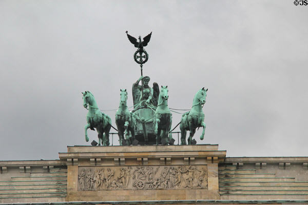Four horses of quadriga of Victory atop Brandenburg Gate. Berlin, Germany.